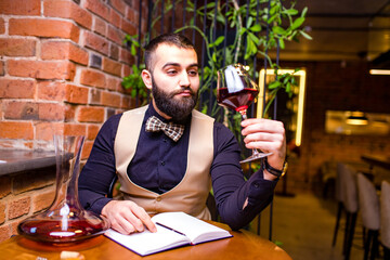 arabian man sommelier appreciating drink in lux hotel