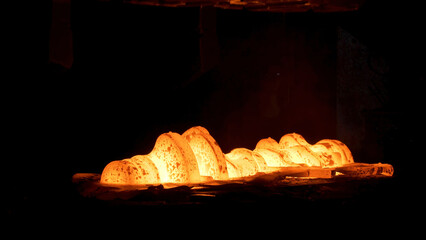 Steel quenching at high temperature in industrial furnace at the workshop of a forge plant. Scene....