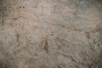 Destroyed cracked wall background, brown light texture, paint streaks.