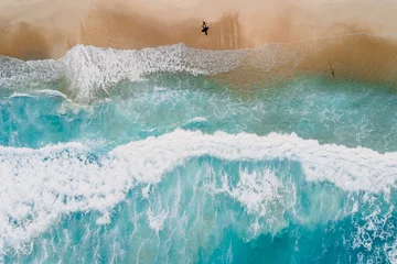 Rolgordijnen Surfer on tropical sandy beach with blue transparent ocean and waves. Aerial view © artifirsov