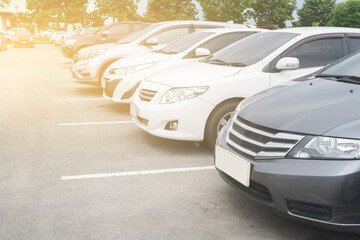 Close up front view car parking in a row in stock background. Vehicle cars transportation trip inventory
