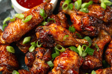 Baked chicken wings with spring onion and sweet chili sauce.