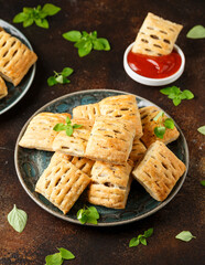 Mini beef patties with vegetables and red wine wrapped in puff pastry