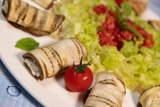 RECIPE FOR GRILLED AUBERGINE ROLL STUFFED WITH RICOTTA CHEESE AND SALAD WITH VINAIGRETTE. High quality photo