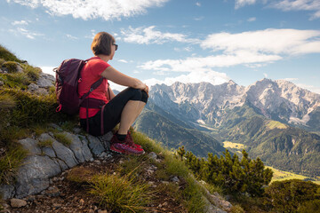 Naklejka na ściany i meble Woman backpacker enjoy the view at mountain hike in nature.