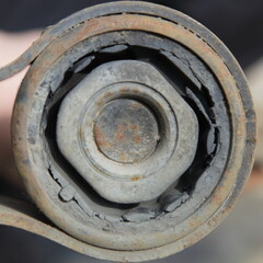 Old damaged metal rubber mounting silent block closeup