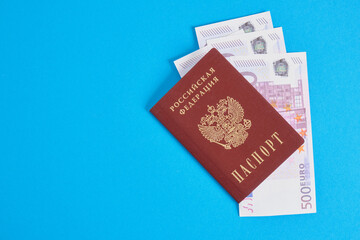 several 500 euro banknotes in the passport of a citizen of Russia, travel and saving money concept