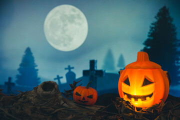 Spooky cemetery with glow halloween pumpkin