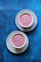 Homemade blueberry yogurt in ceramic bowl. Healthy breakfast on a table. Balanced diet concept. 