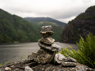 Cairn or stones arranged in a mound in front of mountains to symbolize peace and dedication.