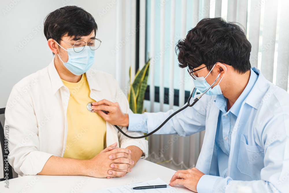 Wall mural Doctor listening to patients breathing sound with Stethoscope