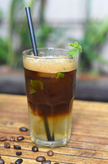 Ice lime espresso with mint and coffee beans on wooden table