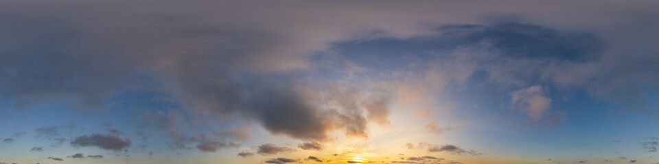 Panorama of a dark blue sunset sky with golden Cumulus clouds. Seamless hdr 360 panorama in...