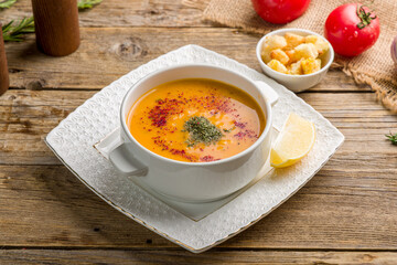 Lentil soup with lemon on wooden table. Turkish cuisine