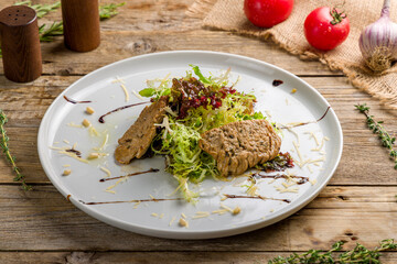 Steak salad with beef on white plate on old wooden table