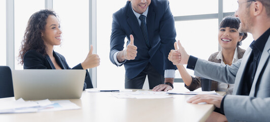 Diversity group of business people thumb-up smiling working together at office celebrating success