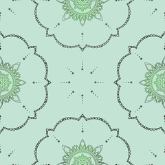 Seamless vector pattern with hand drawn mandala design with floral and dots. isolated on a soft green background. Perfect for printing on fabric or paper.