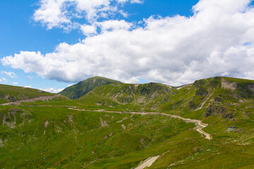 Landscape from Transalpina serpentines on a summer day with  a beautiful sky. Alpine routes in Romania and the highest mountain asphalt road in Romania and the Carpathians mountains