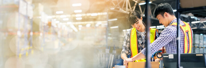 A man and women in charge of large warehouse checking the number items in warehouse that he is responsible for. checking goods in warehouse by scanning a barcode web banner with copy space on left