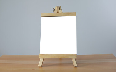 A mini blank whiteboard on  wooden table