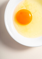 Raw eggs. Close up. flat lay raw eggs yolk in bowl. Isolated broken white background.