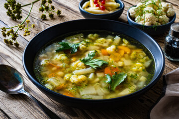 Cauliflower soup on wooden table
