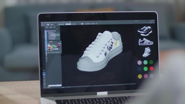 Close Up Of A Laptop On The Table Showing Video Of Rotate 3D Model Of Shoe. Shoe Production Procedure Concept. Cyber Games Clothing And Footwear Line
