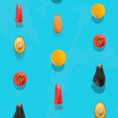 Creative vegetables pattern made of tomato, red paprika, eggplant, avocado, egg yolk and almond on blue blackground.  Flat lay.