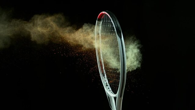 Super Slow Motion Detail Shot of Hitting Tenis Ball Containing Color Powder by Racket at 1000 fps.