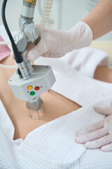 Procedure for laser removal of neoplasms on the abdomen in a cosmetology clinic