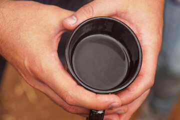 Holding black coffee cup