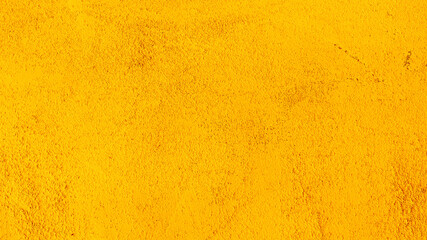 Abstract background of old yellow plaster on the wall.