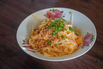 top view, thai food, pad Thai food on a ceramic plate, placed on a wooden table, food, object, copy space