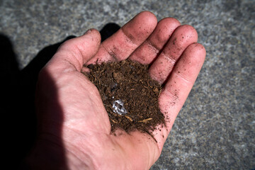 Hand with a simulated diamond pretending to have been found on earth