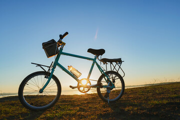 Naklejka na ściany i meble Bicycle in the morning sunshine by the lake.