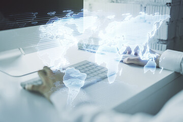 Double exposure of abstract digital world map and hand typing on laptop on background, research and strategy concept