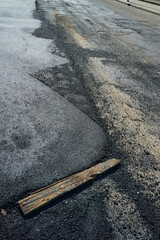new asphalt freshly applied by heavy machinery on a renovated street. New pavement concept.
