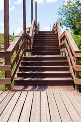 the wooden staircase with railings is painted with brown paint