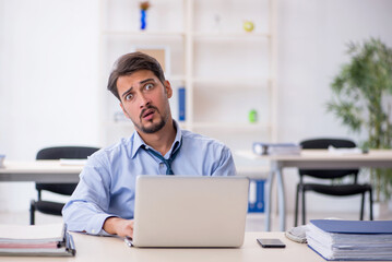 Young male employee working in the office