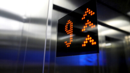 In elevator of modern business center on electronic LCD display. Interior of the elevator inside. View of the panel with the number and steel silver lining. monitor show number floor in elevator