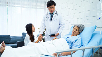 Fototapeta premium Specialist male doctor came to report the worsening symptoms of elderly female patients. The female patient's daughter asked a male doctor to help her mother to the best of his ability. 