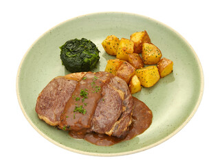 grilled beef fillet steak with gravy sauce with spinach butter and home fried potatoes Isolated on white background.