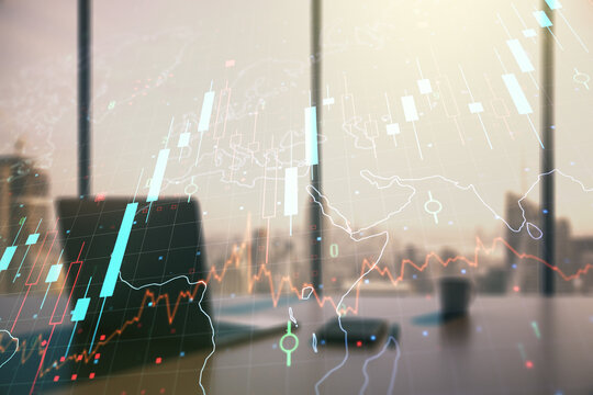 Double exposure of abstract creative financial chart with world map and modern desktop with laptop on background, research and strategy concept