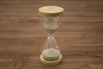 Image of a sand hourglass. Reference to the passing of time