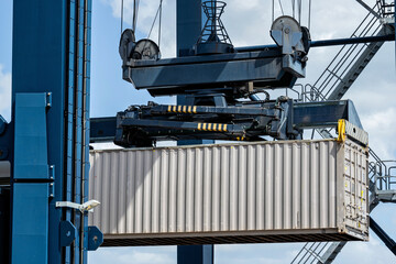 40 ft intermodal container being lifted by spreader in seaport