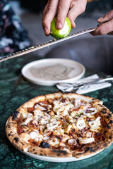 Grated lime on delicious traditional Italian pizza