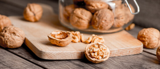 Fototapeta na wymiar Healthy bio walnuts on wood desk with detail background, walnut on wood kitchen underlay.