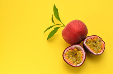 peach and passion fruit on a yellow background, copy space