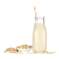 Oat milk in a traditional bottle. Vegan, plant based, non dairy. Side view with ingredients...