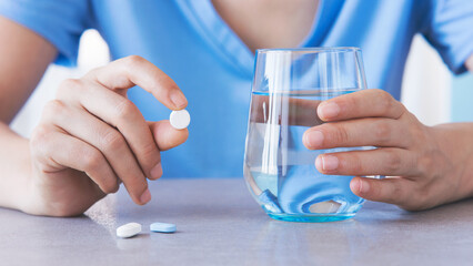 Woman taking her daily prescription pills